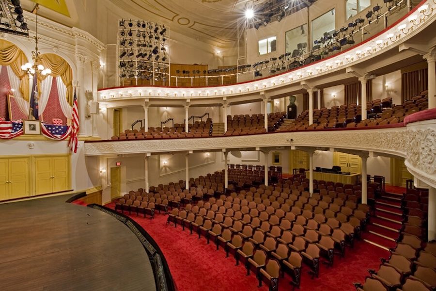 Interior of Ford's Theatre with red velvet carpet and two balconies. 