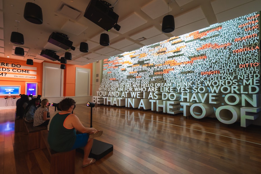 Visitors sit and interact with a dynamic word display at Planet Word, a language-focused museum in Washington, DC.