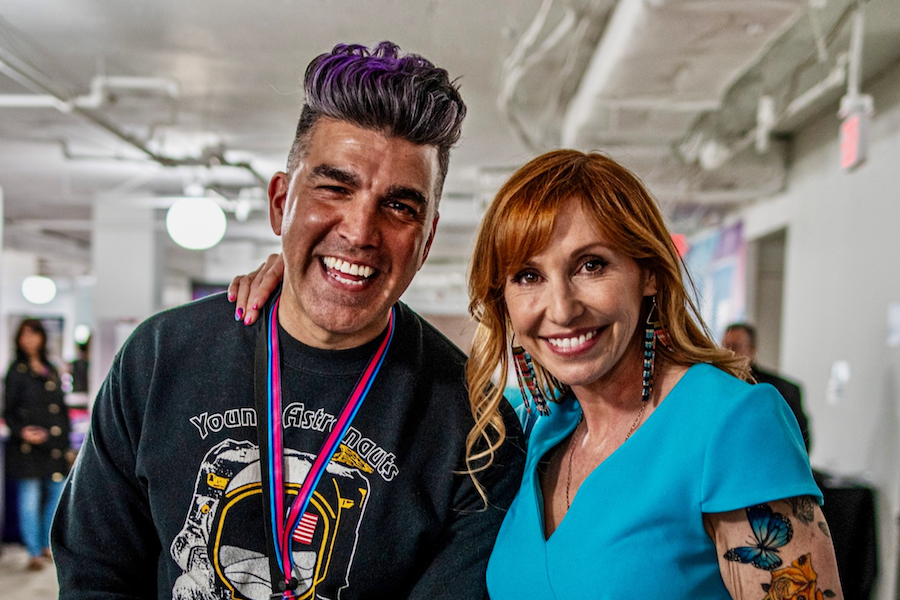 Two convention-goers smile for a photo.