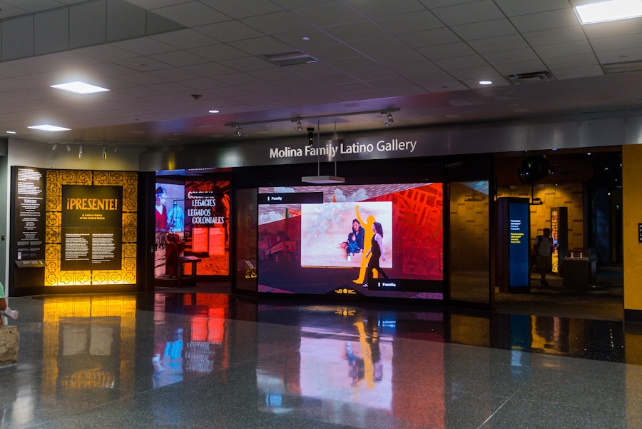 Entrance to the Molina Family Latino Gallery with bright exhibits and signage.