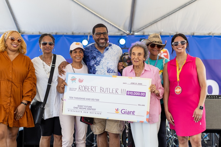 A group poses with an oversized check celebrating a contest winner at the event.