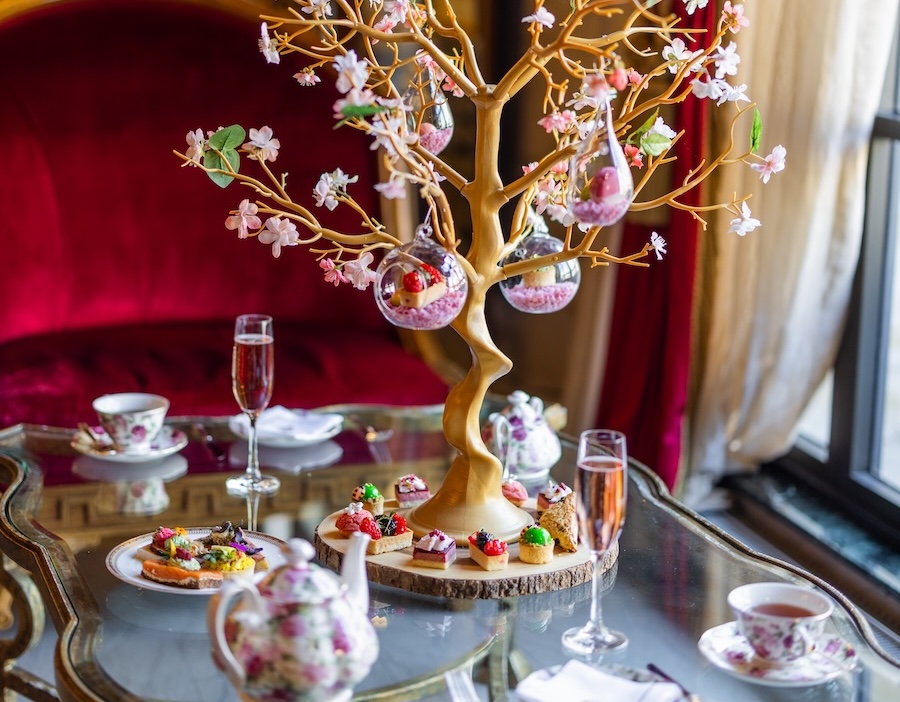A decorative dessert display features delicate sweets hanging from a blossom-like centerpiece.