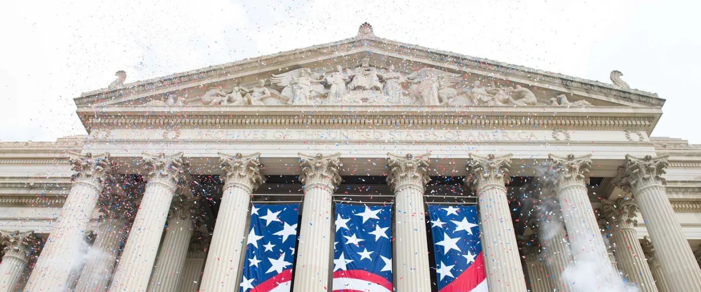 Neoclassical building with columns and patriotic banners hanging between them