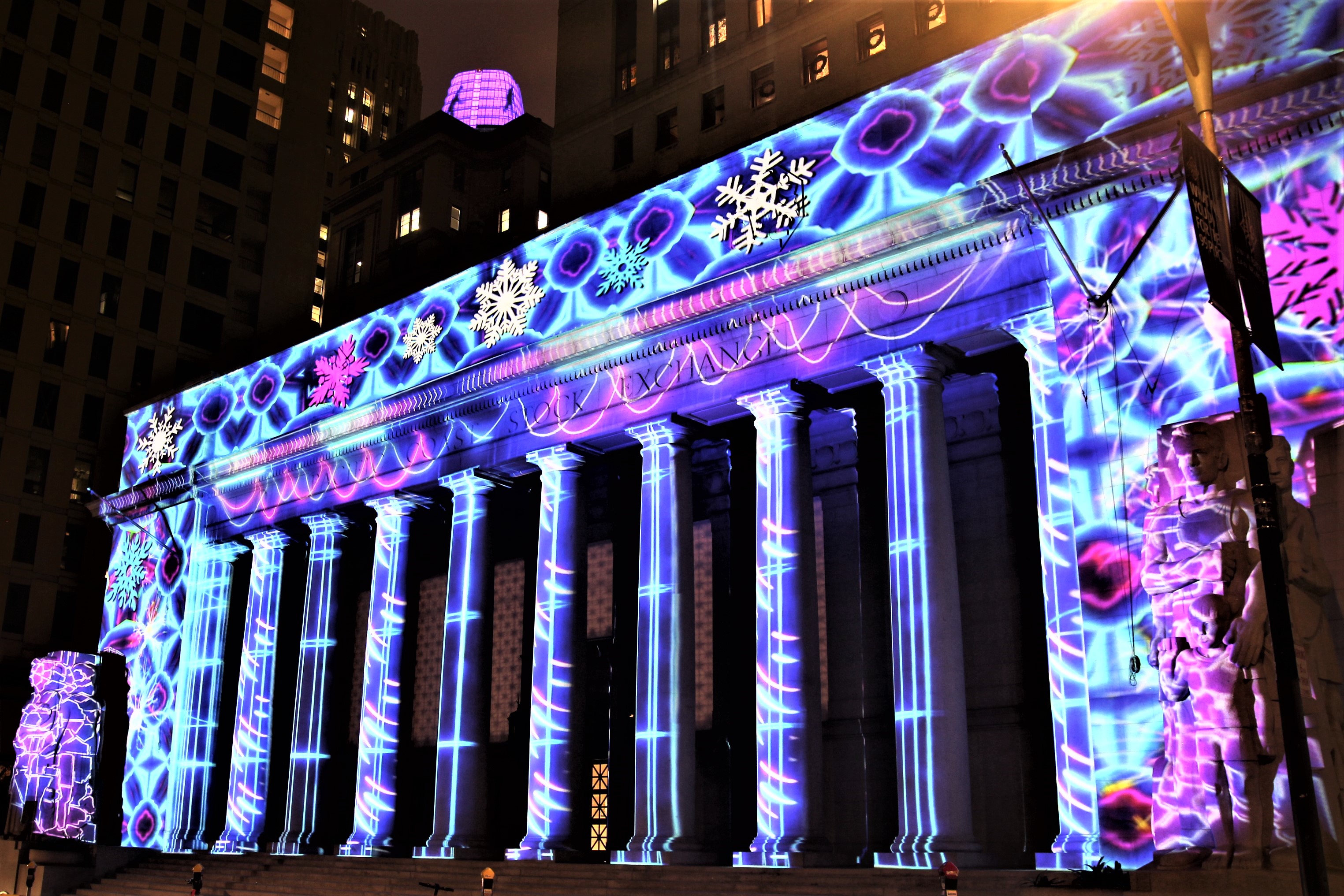 A vibrant light projection covering an historic building