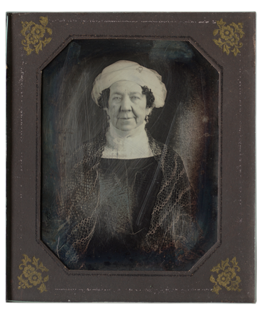 A daguerreotype portrait of Dolley Madison, wearing a head covering and shawl, set in an ornate frame.