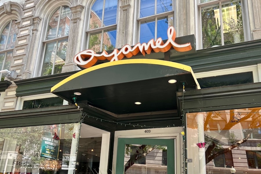 Exterior view of Oyamel Cocina Mexicana with its signature sign and entrance.