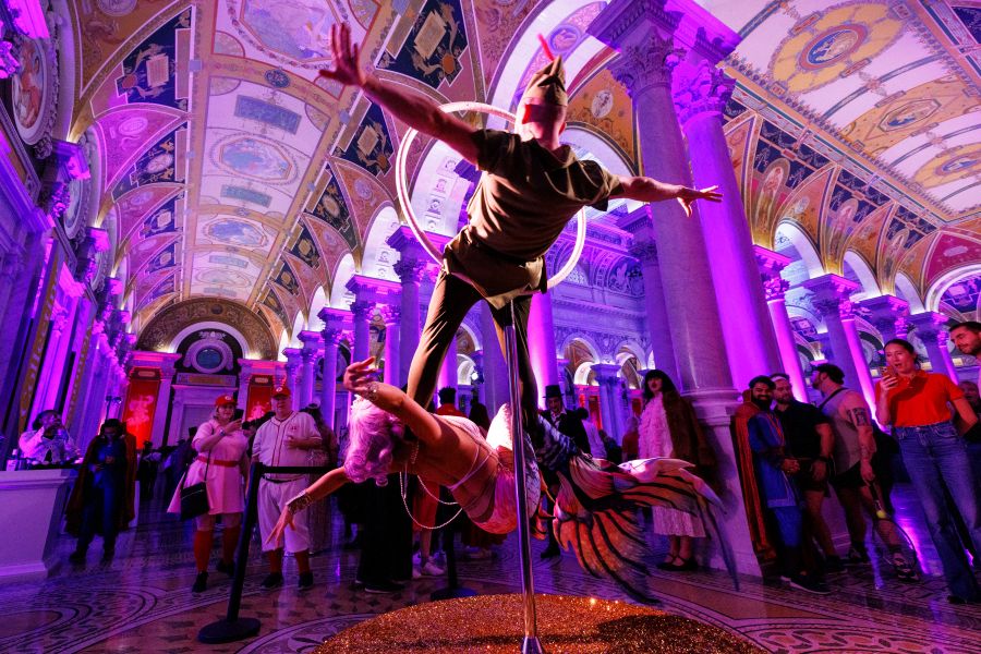 Two live performers being watched at the Library of Congress in fun costumes