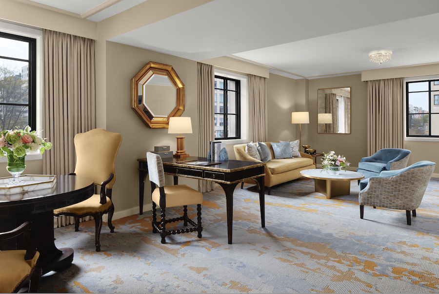 An elegant hotel suite with natural light and a light color scheme. 