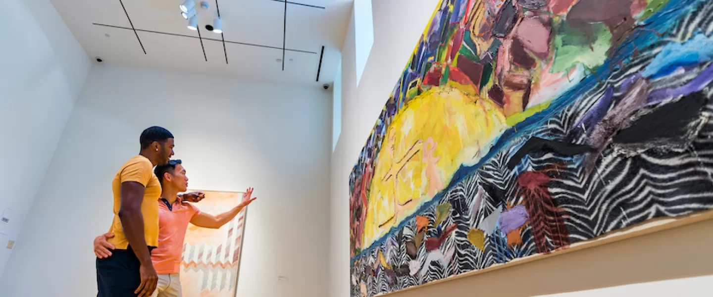 Two people admire a large colorful painting at The Phillips Collection.
