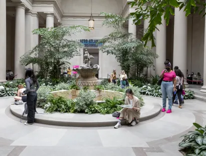 Visitors gather around a fountain in the National Gallery of Art’s Sculpture Garden courtyard in Washington, DC.